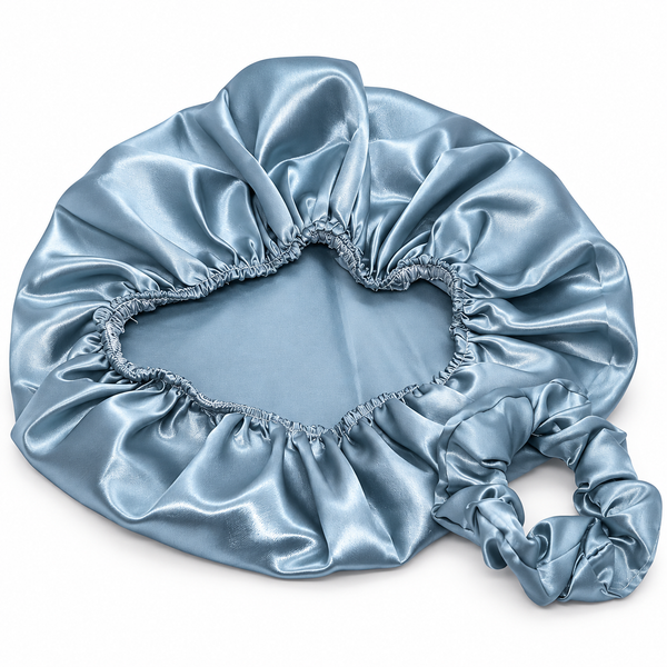 A light blue satin bonnet with an elasticized opening and a drawstring tie, shown on a plain white background.