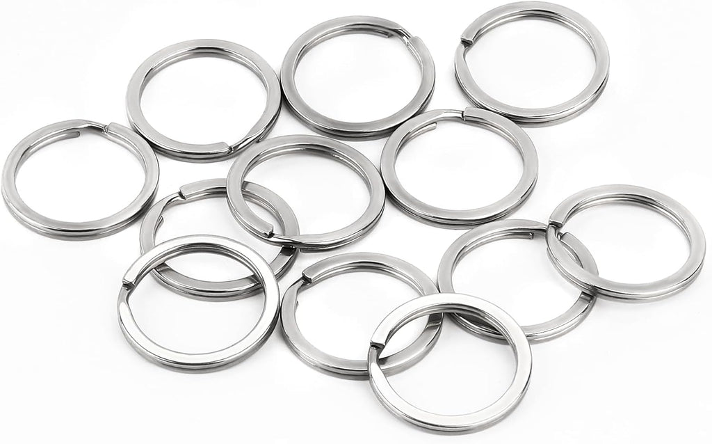 Ten silver metal split key rings arranged on a plain white background.