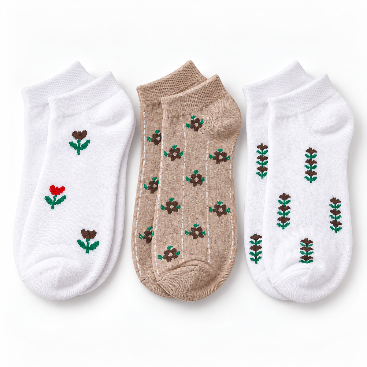 Three pairs of low-cut ankle socks arranged side by side on a white background. The left pair is white with small embroidered flowers in brown and red with green stems.