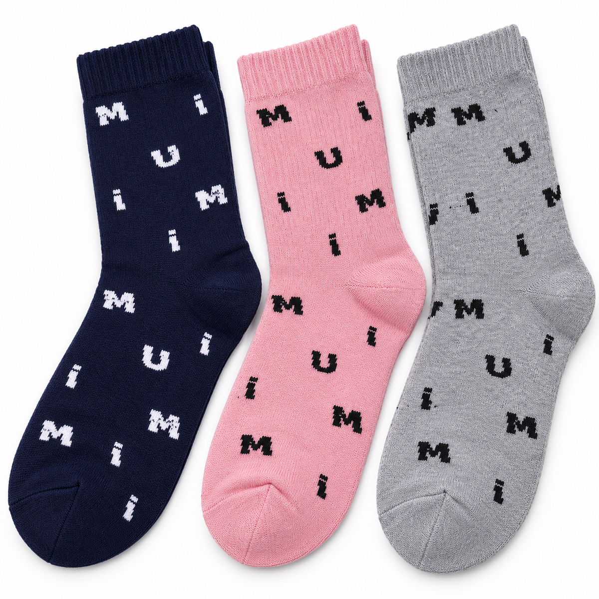 Three pairs of crew socks in navy, pink, and gray, each printed with a repeating pattern of the letters 'M', 'U', and 'i'.