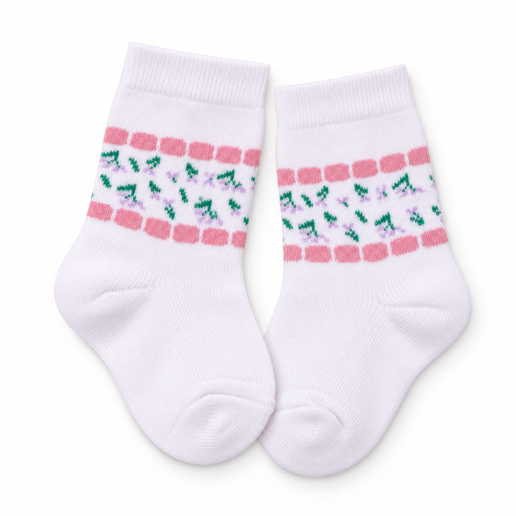 A pair of white baby socks with a decorative pattern of pink stripes, green leaves, and small purple flowers around the upper calf, shown on a plain white background.