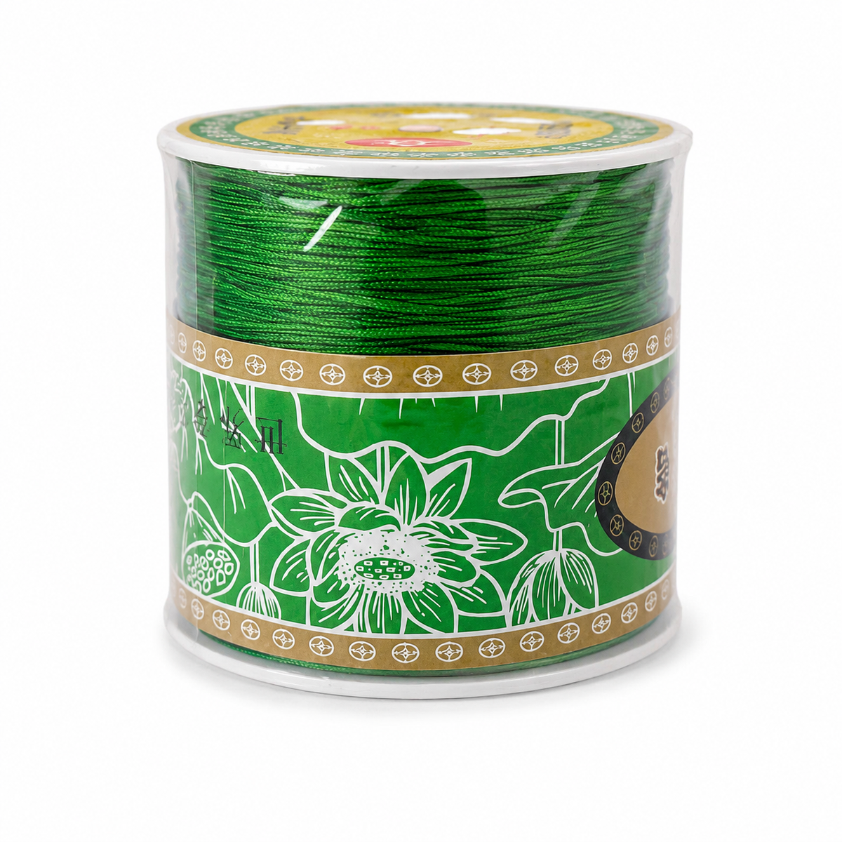 A spool of green embroidery thread with a decorative green, white, and gold label, photographed on a clean white background.