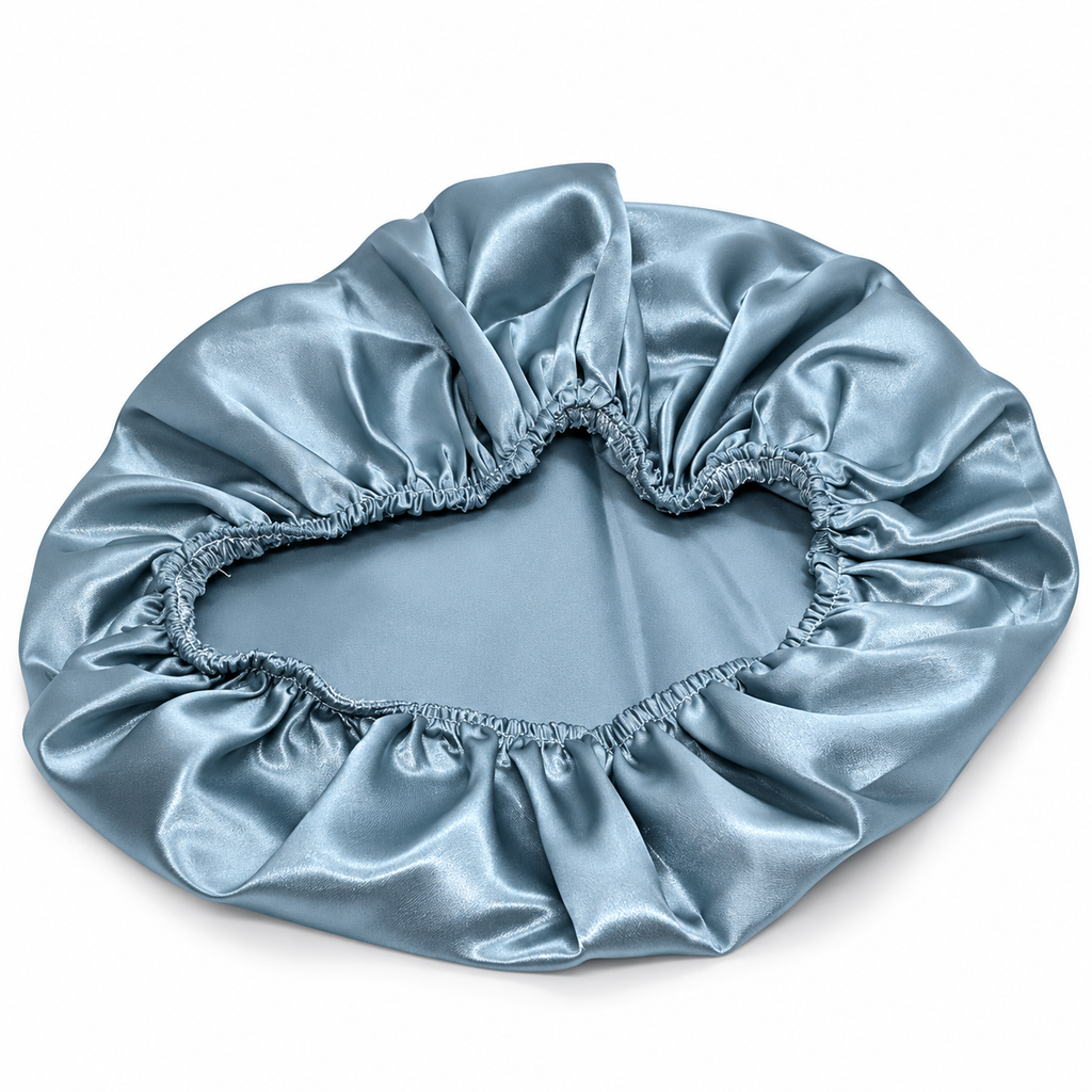 A light blue satin bonnet with an elasticized gathered edge, shown on a plain white background.