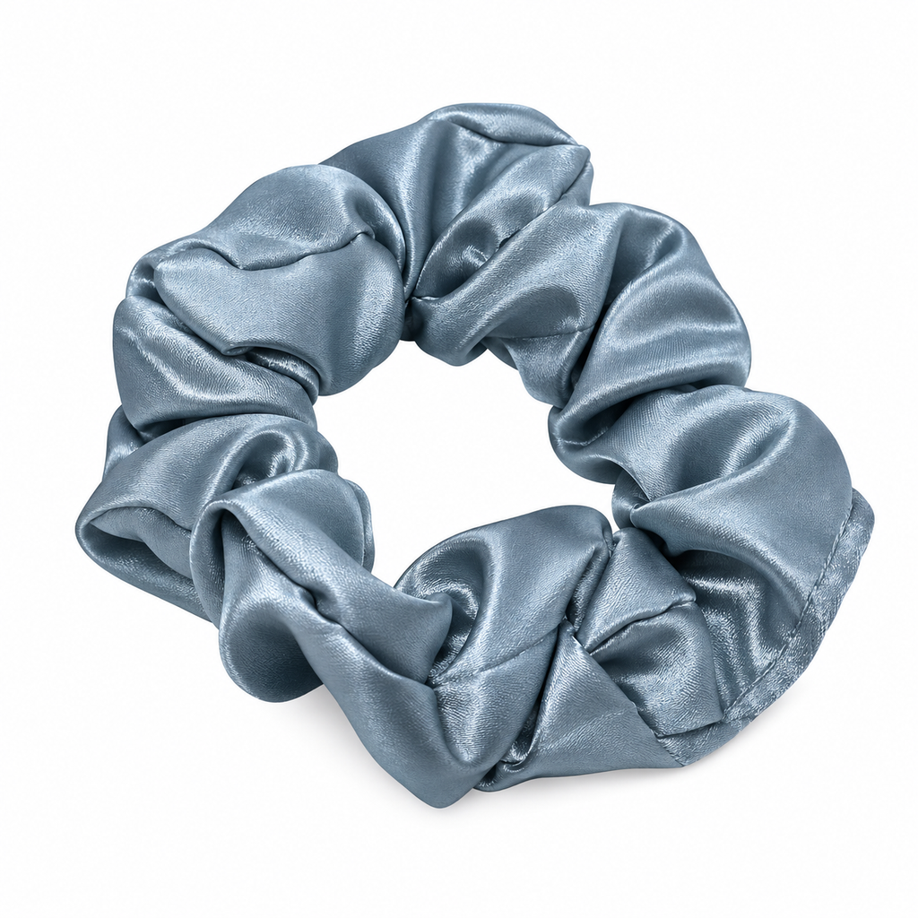 A single satin hair scrunchie in a dusty blue-gray color, displayed on a clean white background.