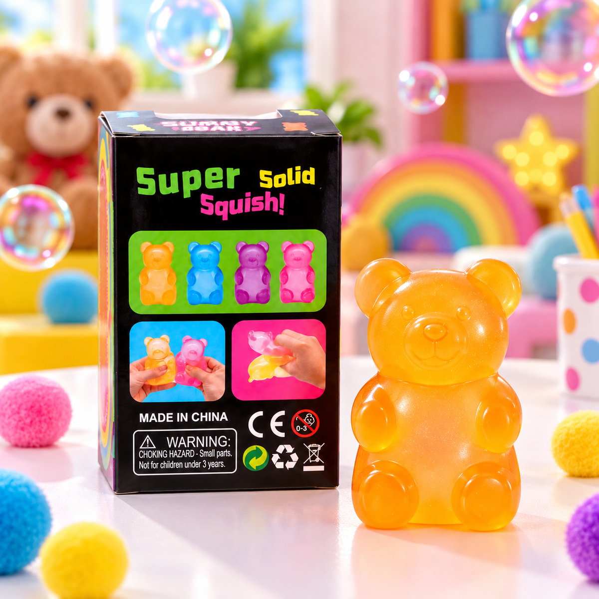 A box of 'Super Solid Squish!' toy gummy bears stands next to a translucent orange-yellow bear-shaped squishy toy on a colorful, playful background with bubbles, pom-poms, and a rainbow.
