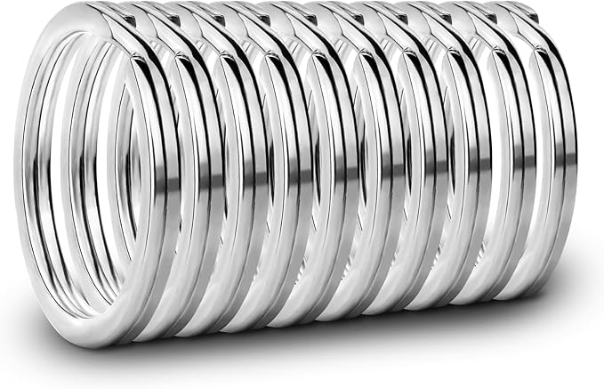 A stack of shiny silver metal spring rings arranged in a neat row on a white background.