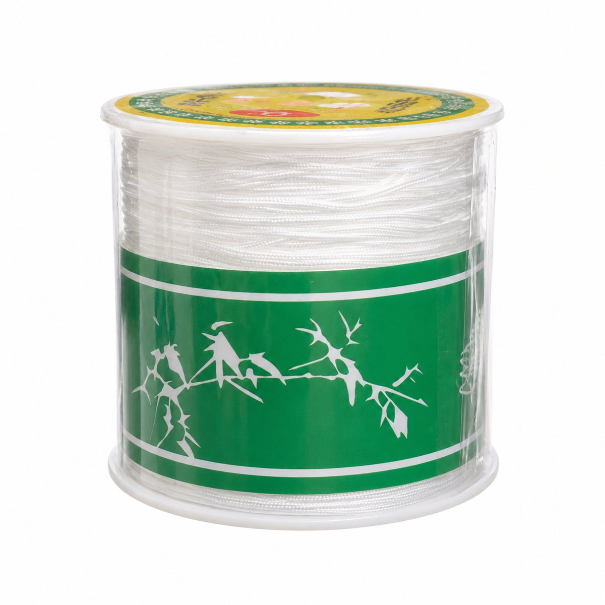A spool of clear thread or cord wrapped around a clear plastic core, with a green paper label featuring white bird and branch silhouettes, on a plain white background.