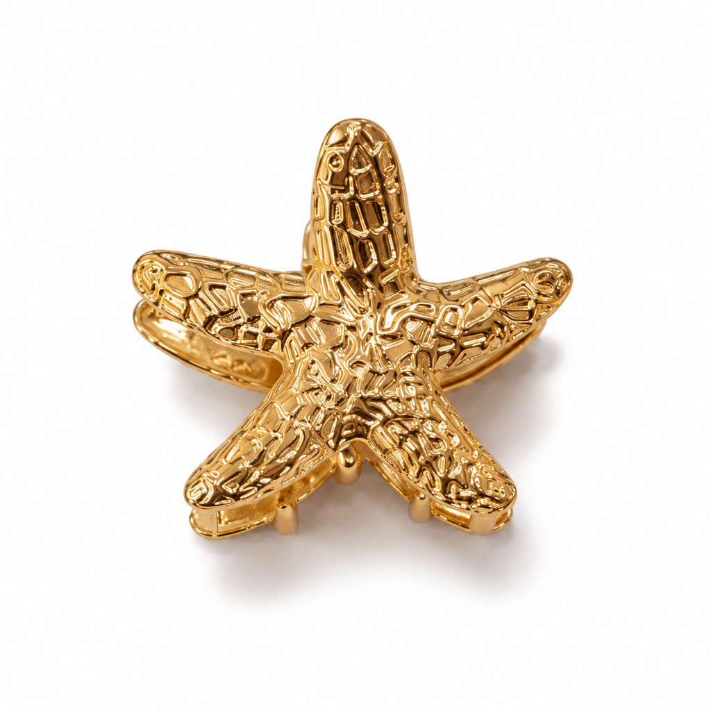 Set of two gold-tone metal hair clips with sea-inspired shapes, ideal for women and girls, featuring claws and decorative designs.