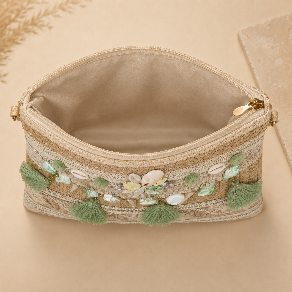 Women’s handmade woven straw clutch bag by 7AGAT with gold chain straps, suitable for shoulder or hand carry.