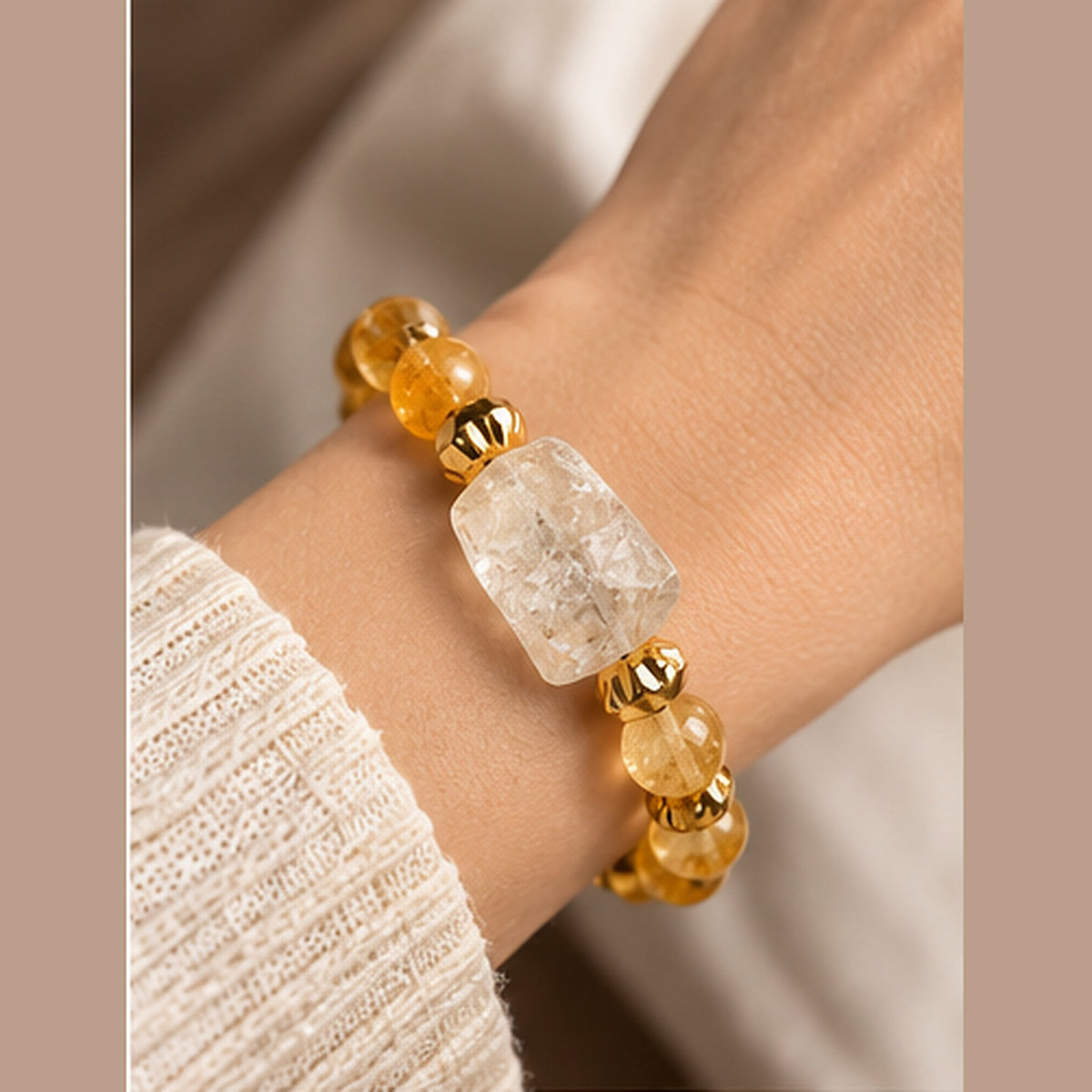 7agat citrine and clear quartz bracelet shown on a wrist with neutral clothing