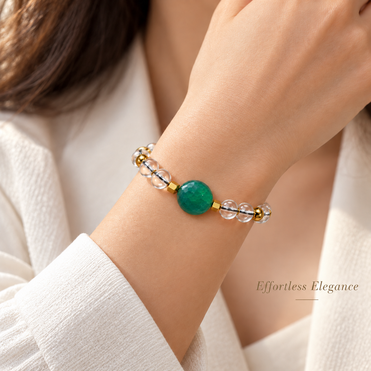 7agat Clear Water Glass and round Green Agate bracelet with Gold Hematite worn on a woman's wrist.