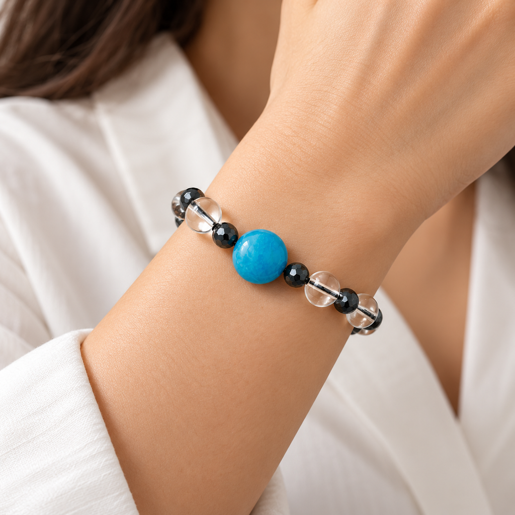 7agat Clear Water Glass bracelet with round Light Blue Agate worn on a woman's wrist.