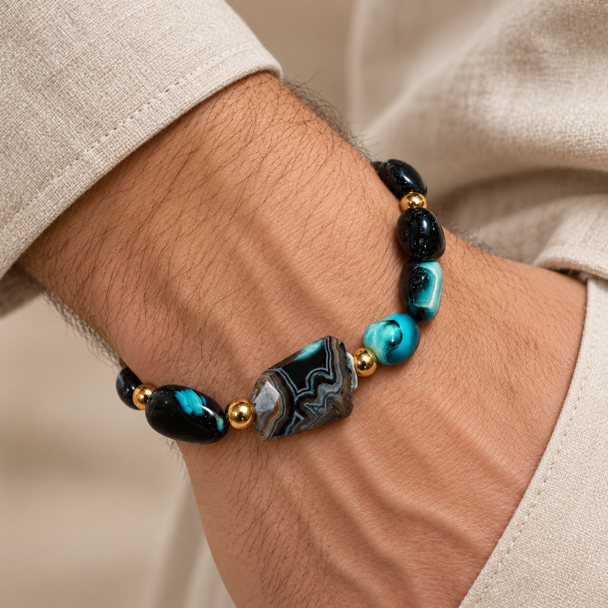 7agat Crazy Cola and patterned Agate bracelet with Gold Hematite worn on a man's wrist.