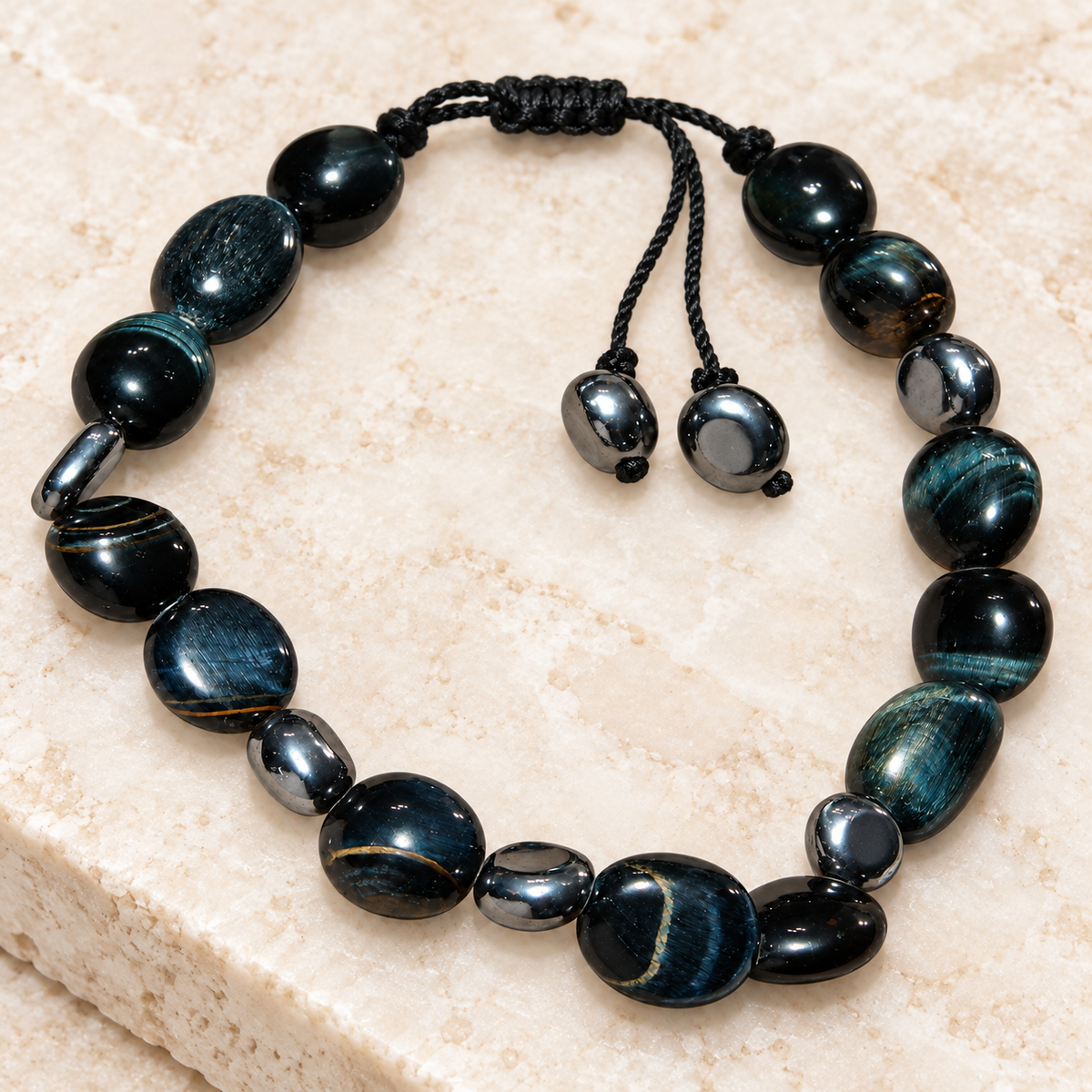 7agat Hawk's Eye dark gemstone bracelet with irregular beads and silver-tone hematite spacers.