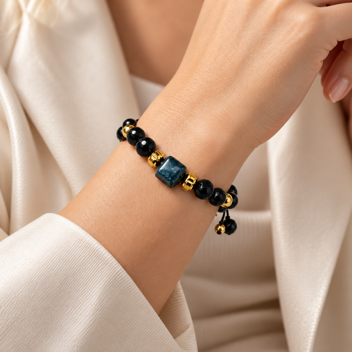 7agat 8mm black Onyx bracelet with blue-black Agate centerpiece worn on a woman's wrist.