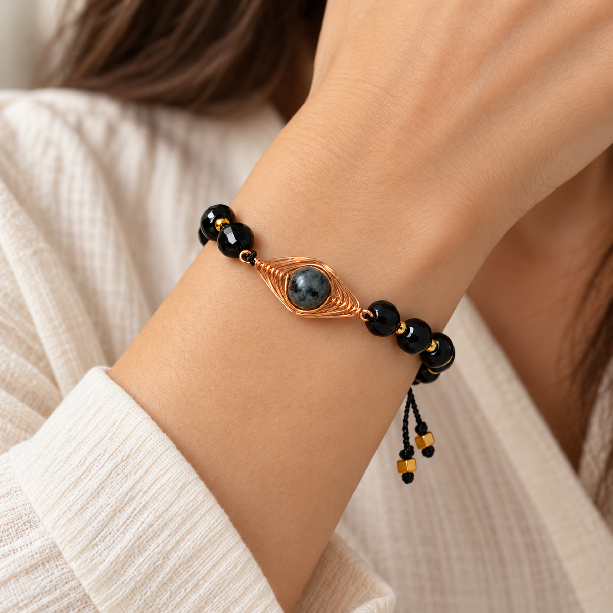 7agat crafted copper and Agate bracelet with faceted Onyx beads worn on a woman's wrist.