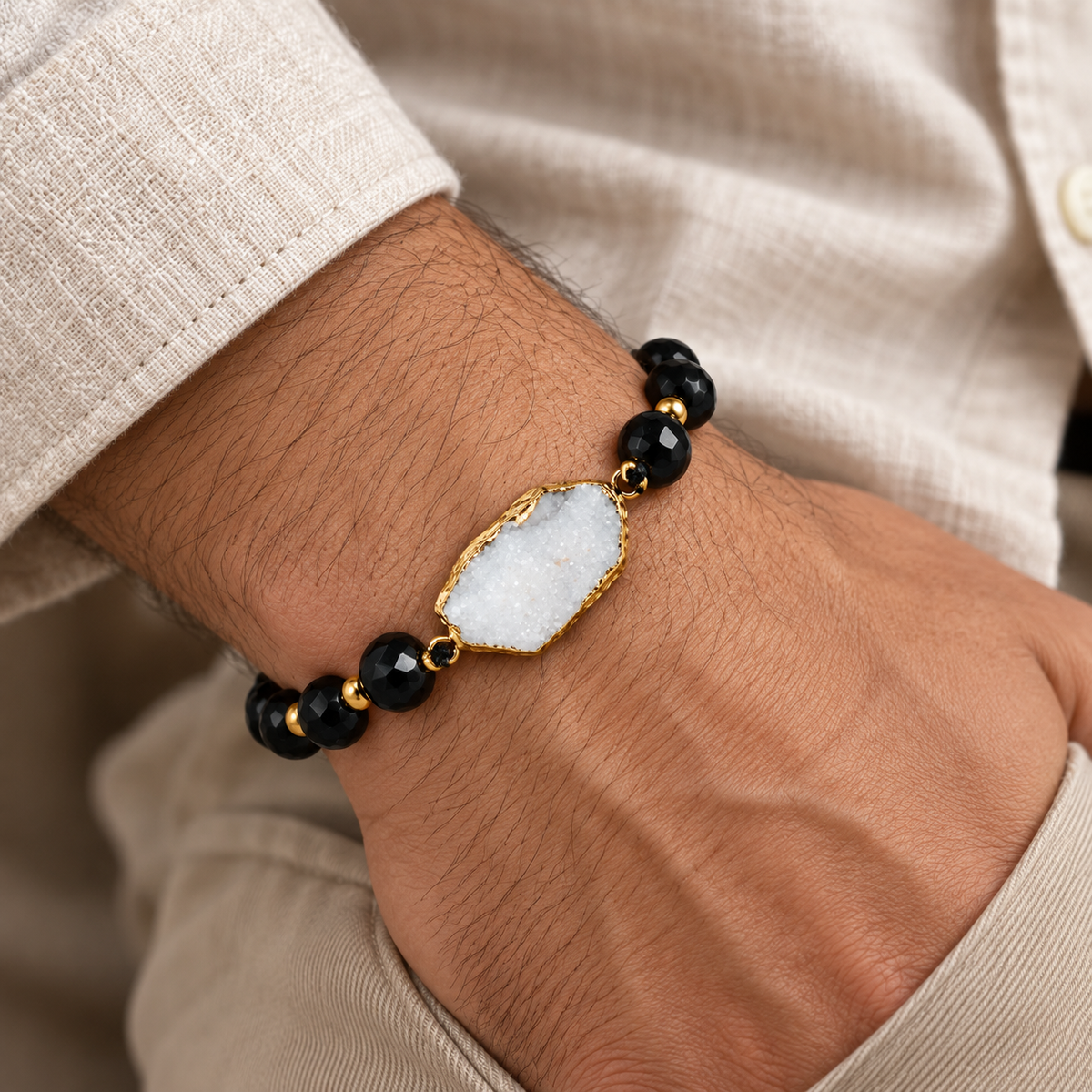 7agat faceted Onyx and white Agate bracelet worn on a man's wrist.