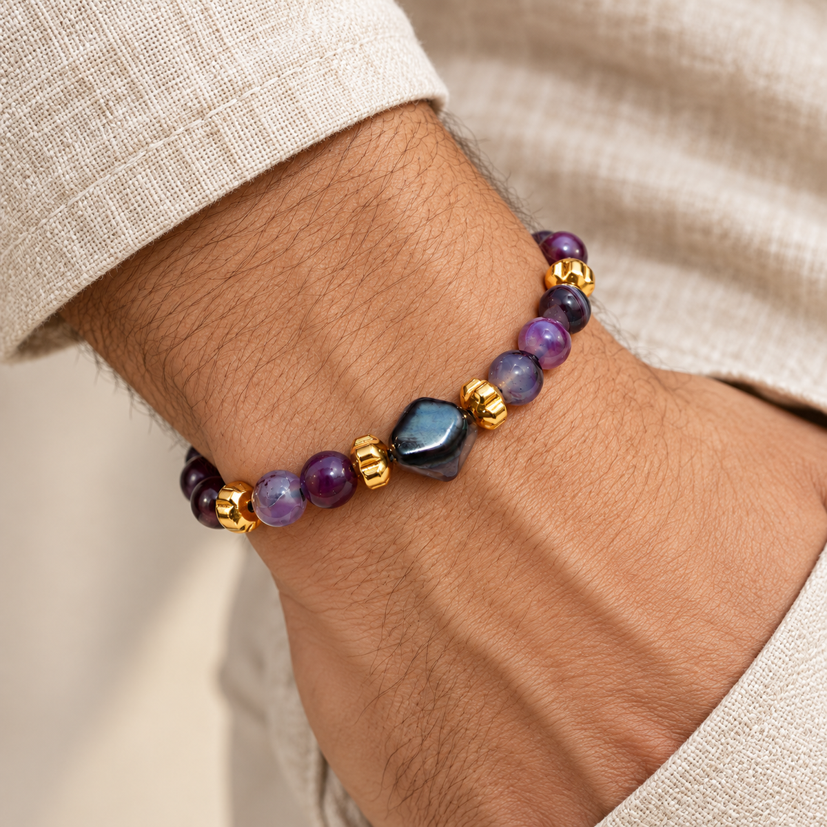 7agat Purple Agate bracelet with Hexagonal Agate and Gold Hematite worn on a man's wrist.