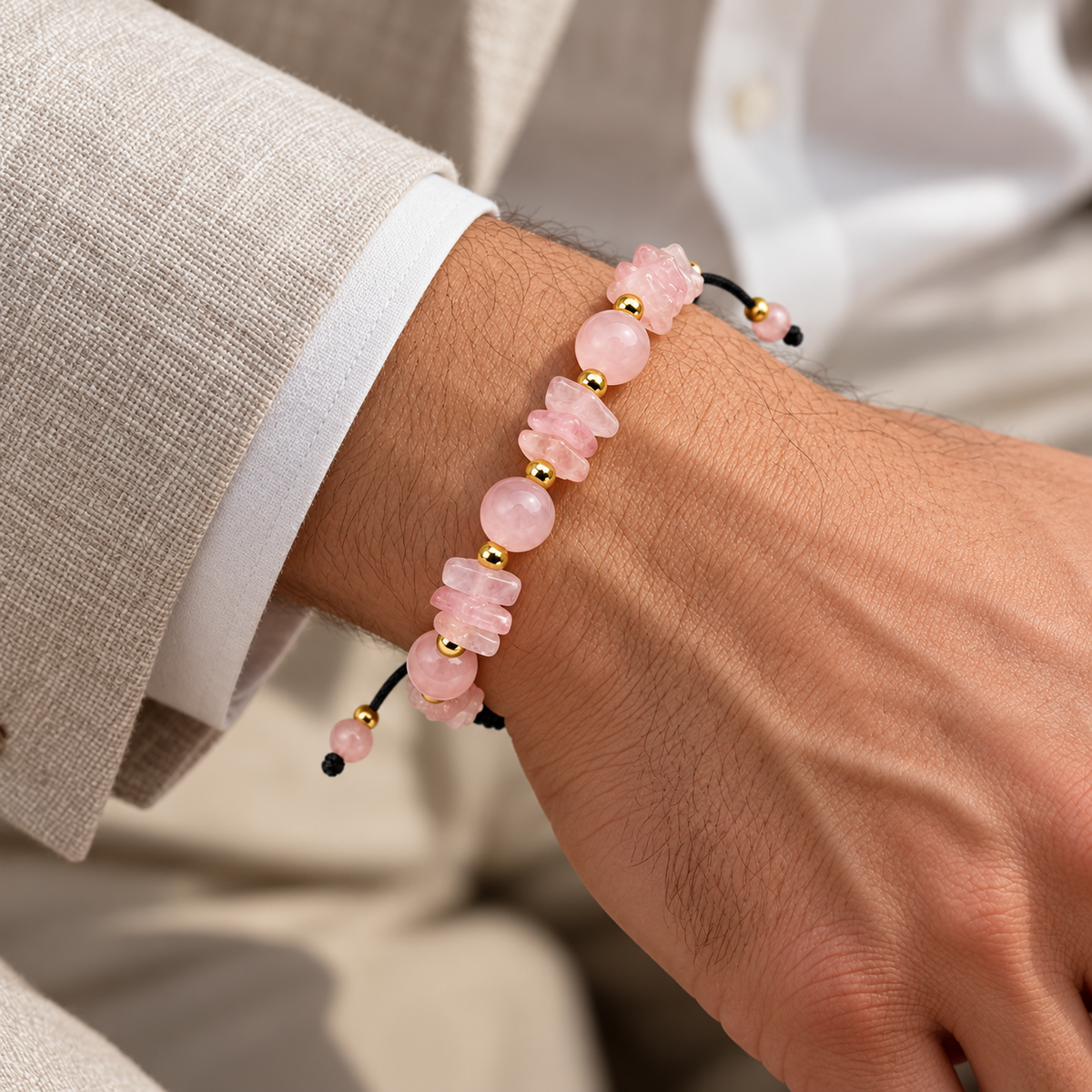 7agat Rose Quartz 8mm beaded bracelet with gold Hematite accents styled on a man's wrist.