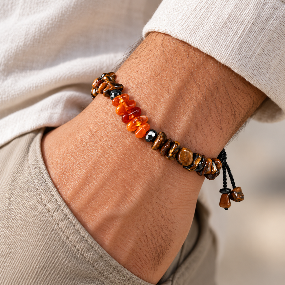 7agat Brown Tiger Eye and Natural Amber bracelet styled on a man's wrist with light neutral clothing.