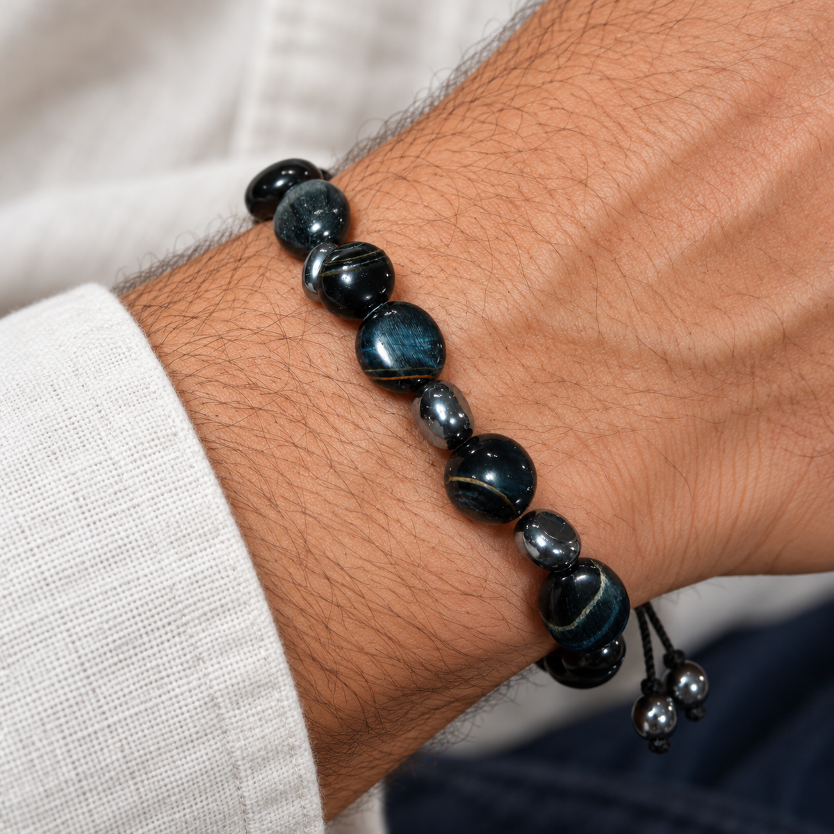 7agat illustrative men's wrist styling for a dark Hawk's Eye gemstone bracelet with silver accents