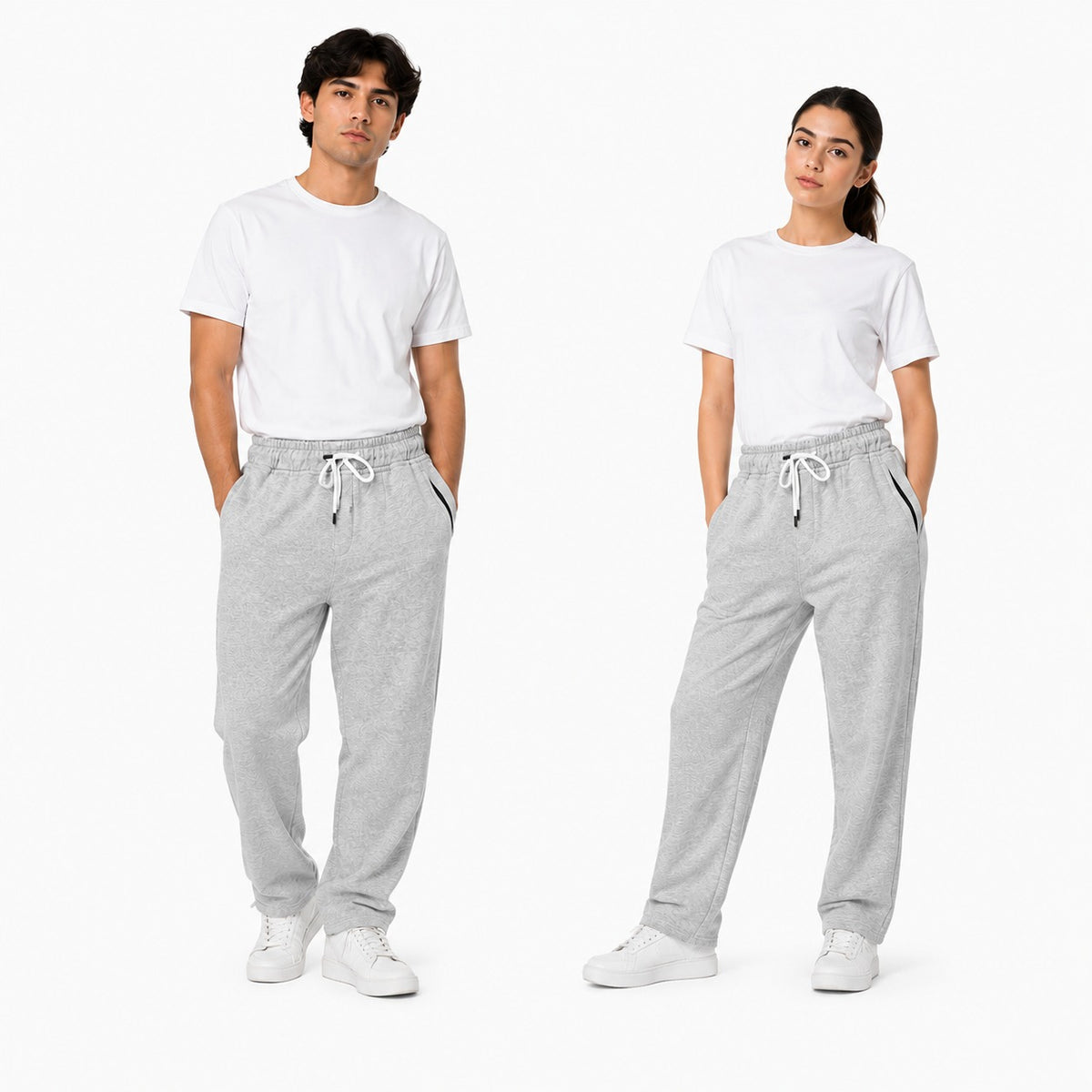 Two models wearing light gray heather sweatpants with white drawstrings, paired with white t-shirts and white sneakers, standing against a plain white studio background.